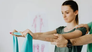 A woman stretching with a stretch band